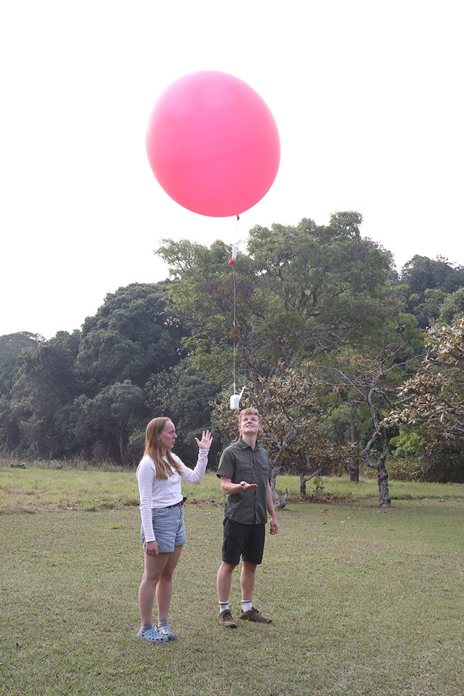 Second year SoGE undergraduates, Alice Jardine and Chris Edmunds, release a weather balloon at Nchila Camp, NW Zambia