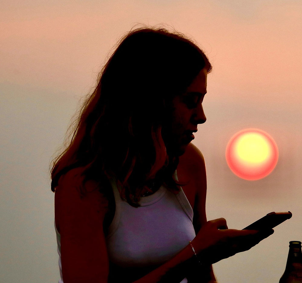 Kitty Attwood, winner of the undergraduate Met office Academic Partnership prize in 2022, now DTP student, checks her phone for the latest satellite imagery