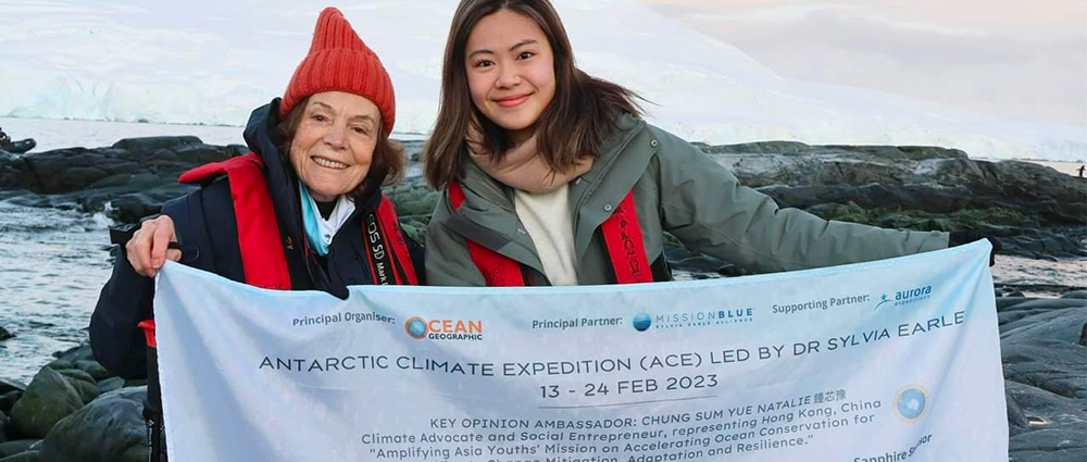 Sylvia and Natalie holding a pledge sign