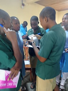 Students from Presbyterian Comprehensive Secondary School Buea and Baptist Comprehensive High School Buea, Cameroon discussing questions for the event speakers.