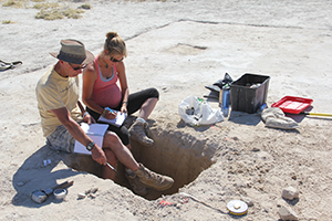 Kalahari fieldwork 2016: inspecting a lake floor sediment pit in Makgadikgadi Pans, Botswana. With Sallie Burrough.