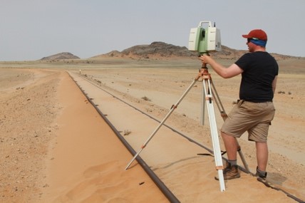 Doctoral student Ciaran Nash surveying the build-up of windblown sand around railway tracks in southern Namibia.