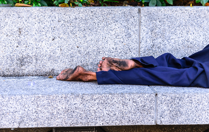 Dirty bare feet on bench