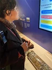 Aissa asking the interactive display on how groundwater levels impact water access.