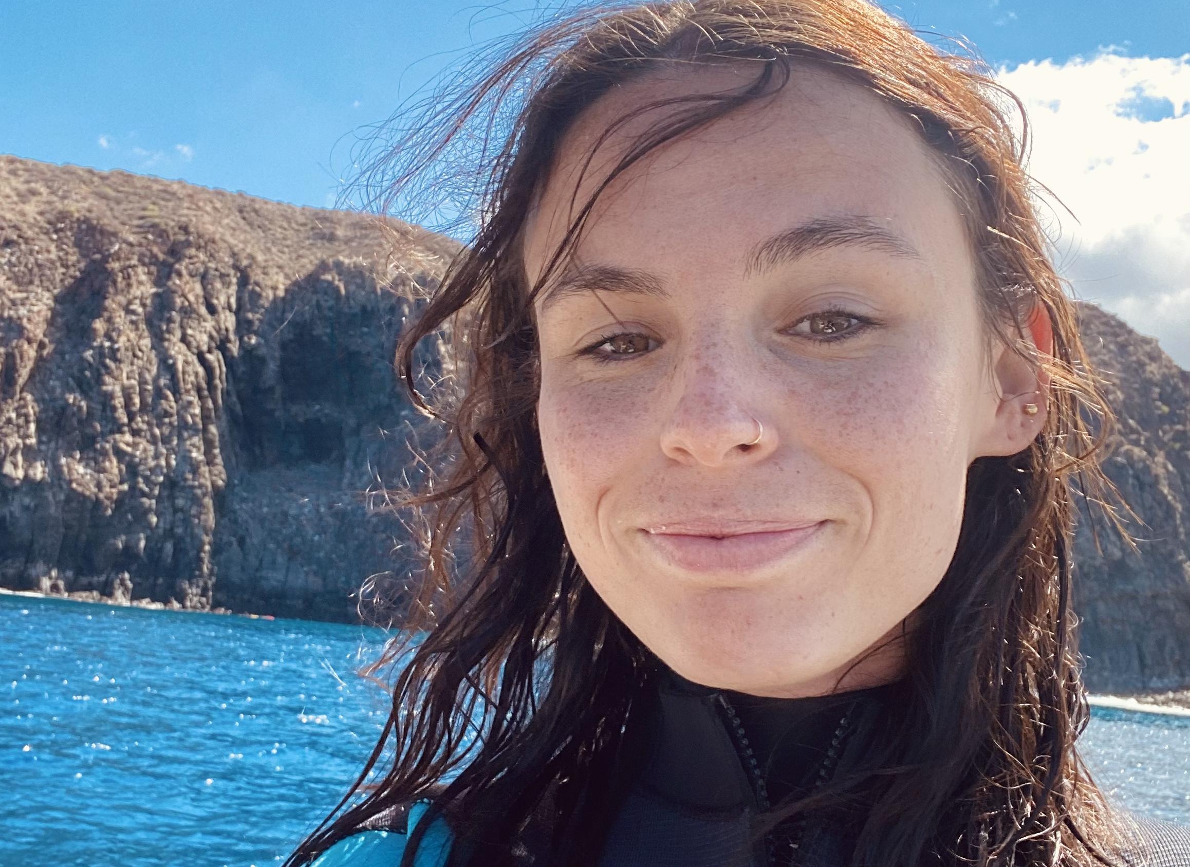 Emma smiling in wetsuit