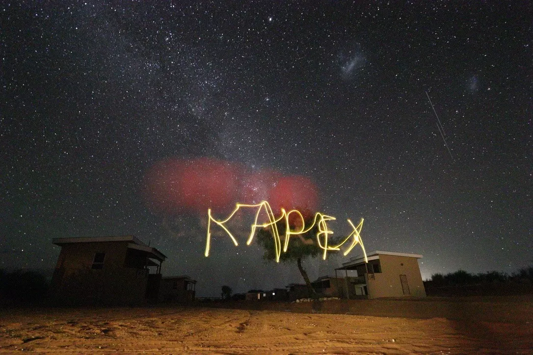The Milky Way, Large Magellanic Cloud and Small Magellanic Cloud are visible in the night sky, as are two satellites in low-earth orbit.