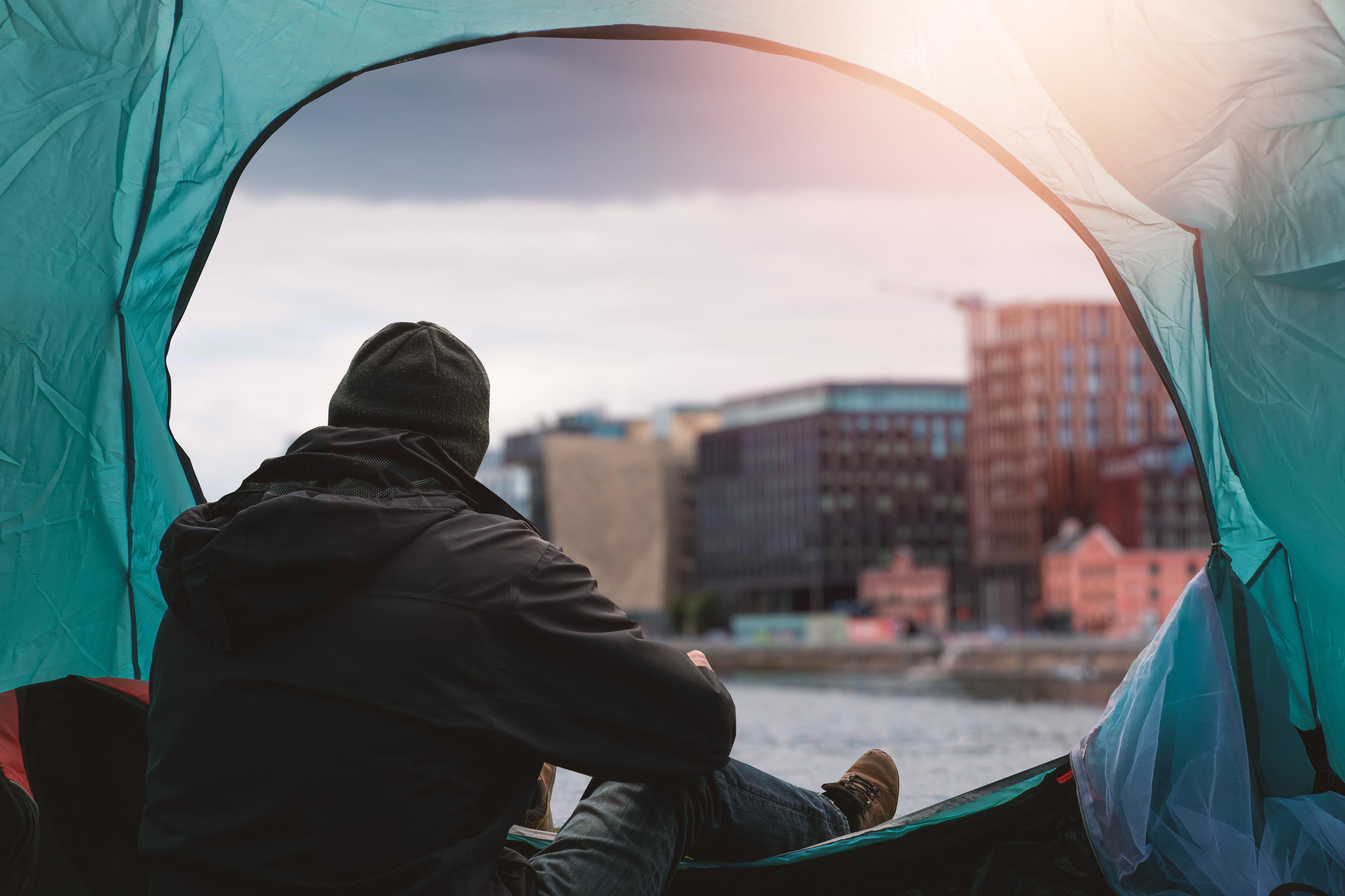 Man in tent in the city
