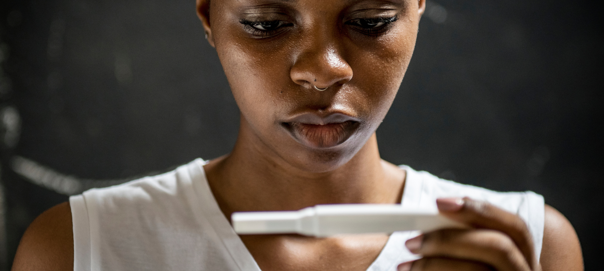 Woman looks at pregnancy test