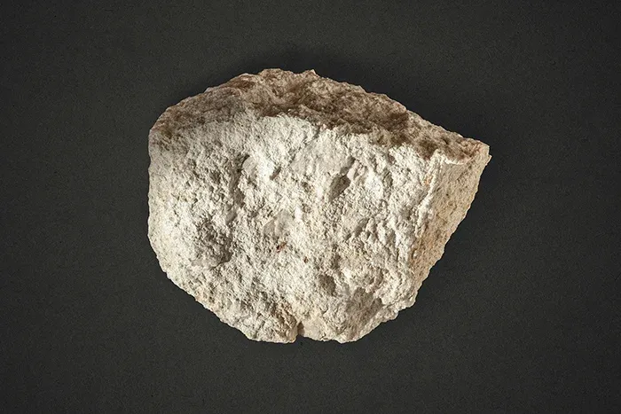 Specimen of Mina do Barroso pegmatite with small spodumene mineralization (translucent crystals). One of the hard-rock sources of lithium. Photo by @miningwatch_portugal on Unsplash.